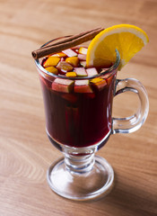 The hot alcoholic drink grog on wooden background
