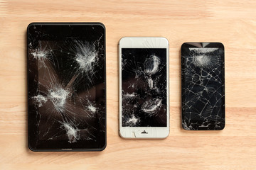 Cracked screen of smartphone mobile black glasses top view photography.