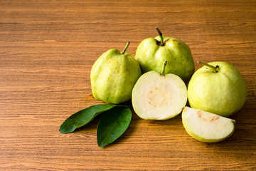 Fresh guava fruit on wooden table background.