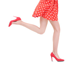 Young woman wearing dress and high heels on white background