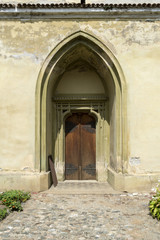 Fototapeta na wymiar Arched door in an old stone building