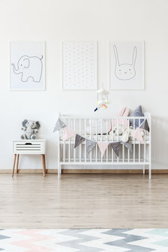 White baby's bed with banner