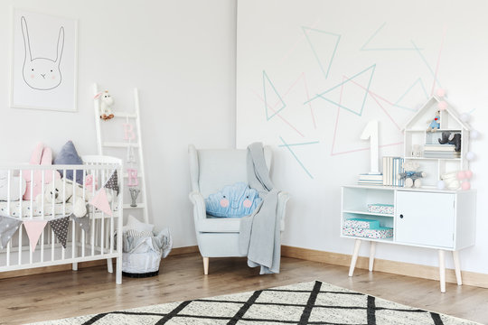 Bright baby's room with armchair