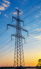 Electricity pylons and power lines, at sunset.