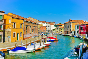 Fototapeta na wymiar View of the colorful Venetian houses along the canal at the Islands of Murano in Venice.