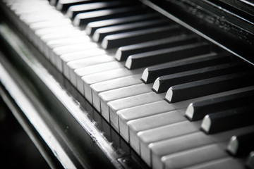 Piano keyboard background with selective focus.A row of piano keys in black and white.