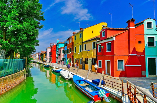 View of the colorful Venetian houses along the canal at the Islands of Burano in Venice.