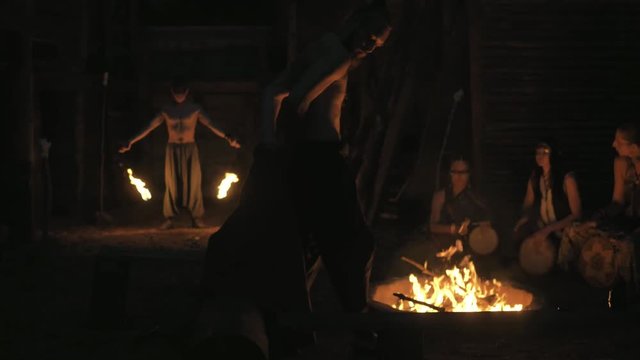 ethno group, they dancing and playing drums and doing fire show