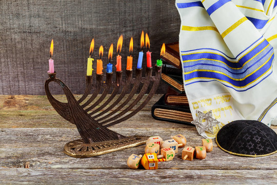 Low key Image of jewish holiday Hanukkah background with menorah traditional candelabra and burning candles