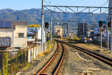 Fototapeta premium Train track at Uji Station with Mountain Backgroud.