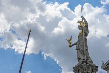 Statue and fountain of Pallas Athena Brunnen, greek goddess of wisdom, in golden helmet in front of Parliament building in Vienna, Austria