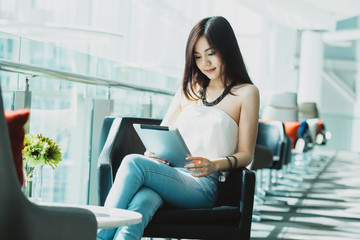 Portrait of beautiful young businesswoman looking tablet at office. Asia people businesswoman.