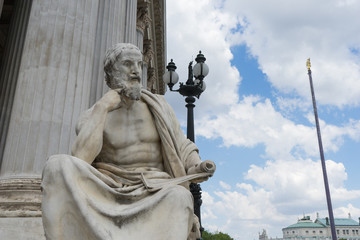 Fototapeta premium Statue of Herodot in front of Austrian Parliament building on Ringstrasse in Vienna, Austria