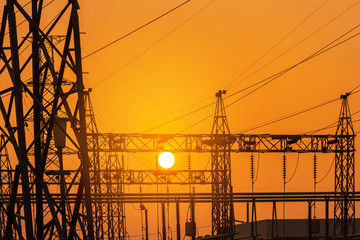 silhouette high voltage electric pillars pylon in electric power plants substation on sunset background  