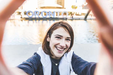 Fotobehang Happy smiling girl taking a selfie in Toronto © william87