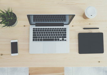 Top view of wooden workplace with coffee, laptop