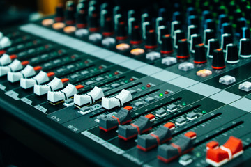 Fototapeta premium Close up of mixing panel sound working at recording studio. Vintage or retro tone.