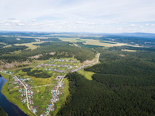 a village hidden among the mountains and forests. Aerial view