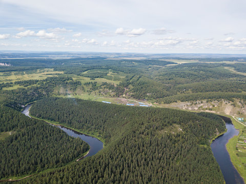 a village hidden among the mountains and forests. Aerial view