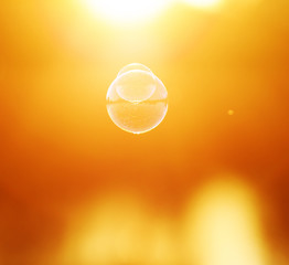 festive background with iridescent soap bubbles flying towards the setting sun