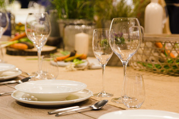Fototapeta premium Table setting decor with cutlery, plates and glasses