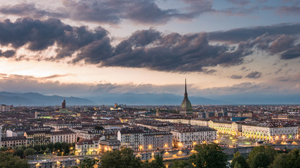 Fototapeta na wymiar Torino Cityscape, Italia. Skyline panoramic view of Turin, Italy, at dusk with glowing city lights. The Mole Antonelliana illuminated, scenic effect.
