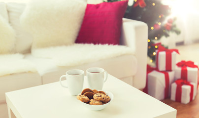 close up of christmas cookies and cups on table