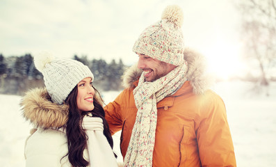 happy couple walking over winter background