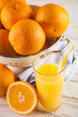 Fresh oranges in a colander