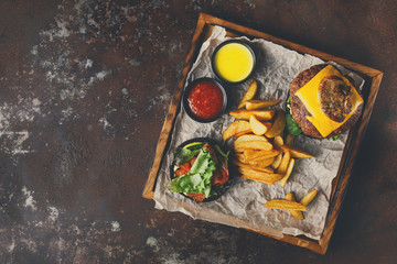 Fototapeta na wymiar Take away burger menu on wooden tray top view