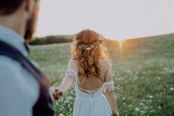 Beautiful bride and groom at sunset in green nature.