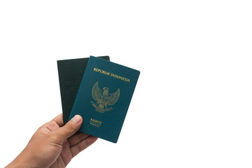 travel concept - hand with passport isolated on white background. Indonesia passport.