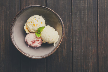 Assorted ice cream scoops in bowl top view