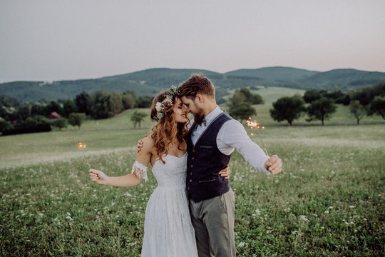 Beautiful bride and groom at sunset in green nature.