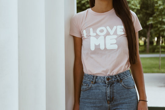 Girl is wearing t-shirt with a text " I love me"