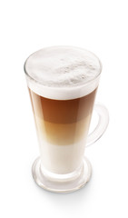 Cappuccino coffee isolated on white background. Foamy coffee and milk drink in a transparent glass cup.