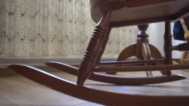 dark brown old rocking chair with slider movement