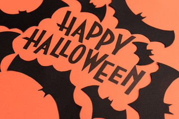 Black logo of Halloween and black bats painted on orange background