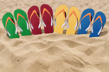 Fototapeta na wymiar Man lifestyle four relax flip flops on orange sandy beach