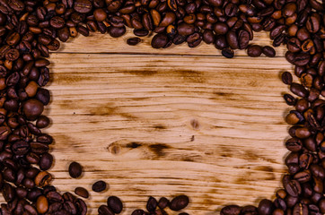Pile of the roasted coffee beans on wooden table. Top view