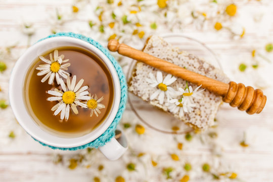 Honeycomb And Chamomile Tea On White