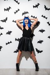 Screaming young woman in witch halloween costume