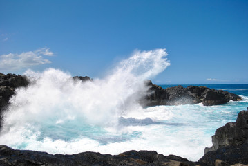 Fototapeta na wymiar Waves crashing on black rocks, Gouffre Etant-salé, Reunion Island, France