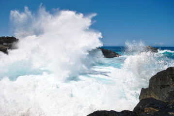 Fototapeta na wymiar Waves crashing on black rocks, Gouffre Etant-salé, Reunion Island, France