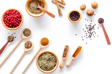 Colorful dry herbs and spices for cooking food white kitchen table background top view pattern