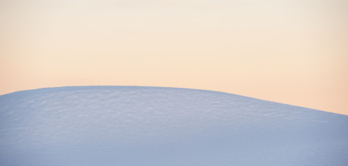 surface of a snowdrift and the sky in the mountains