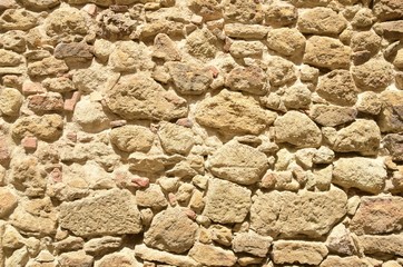 Background of stone wall  in the medieval village of Pals, Girona, Spain