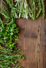 drying fresh herbs and greenery for spice food on wooden kitchen desk background top view space for text