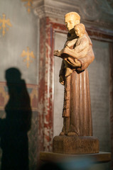 Religious Statue Reading To Child with Shadow