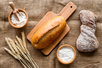 bakery set with fresh wheaten bread on table rystic background top view